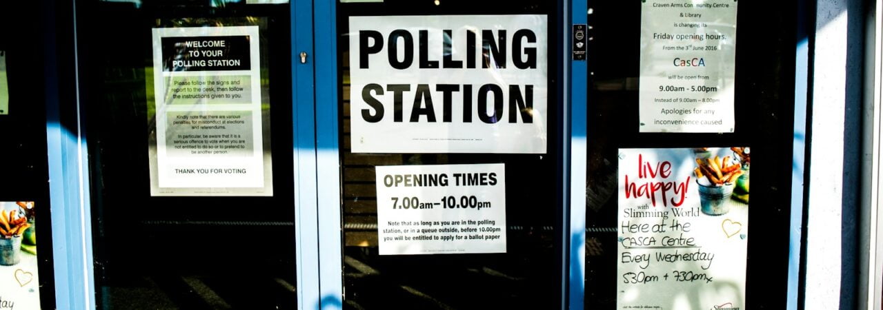 polling station poster on clear glass door